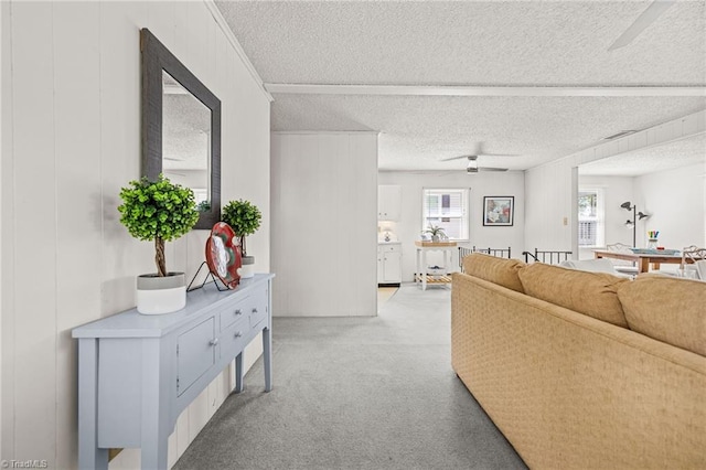 living room with ceiling fan and a textured ceiling