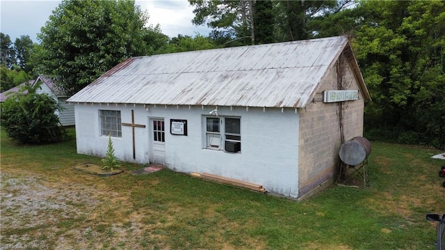 view of outbuilding featuring a lawn