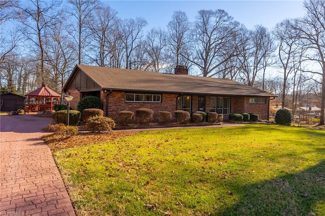 ranch-style house featuring a gazebo and a front yard