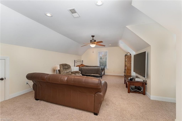 carpeted living room with ceiling fan and lofted ceiling