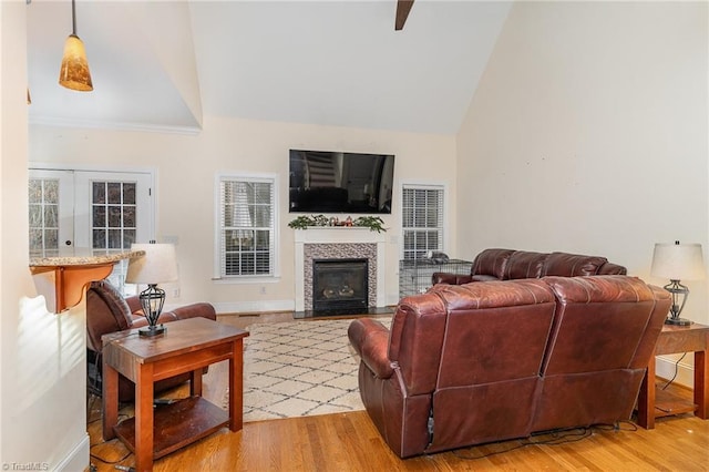 living room featuring hardwood / wood-style floors, plenty of natural light, and lofted ceiling