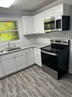 kitchen with white cabinets, appliances with stainless steel finishes, and sink