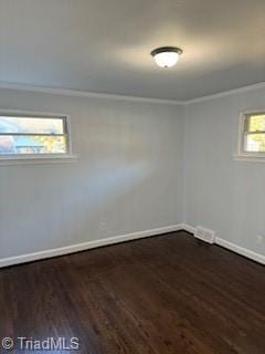 unfurnished room featuring a wealth of natural light and dark hardwood / wood-style floors