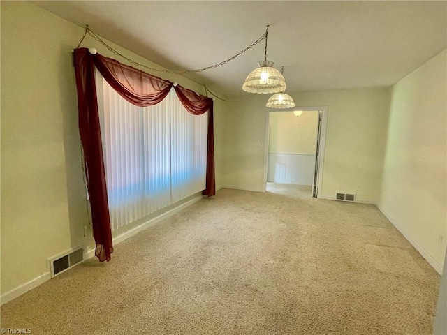 carpeted empty room with visible vents