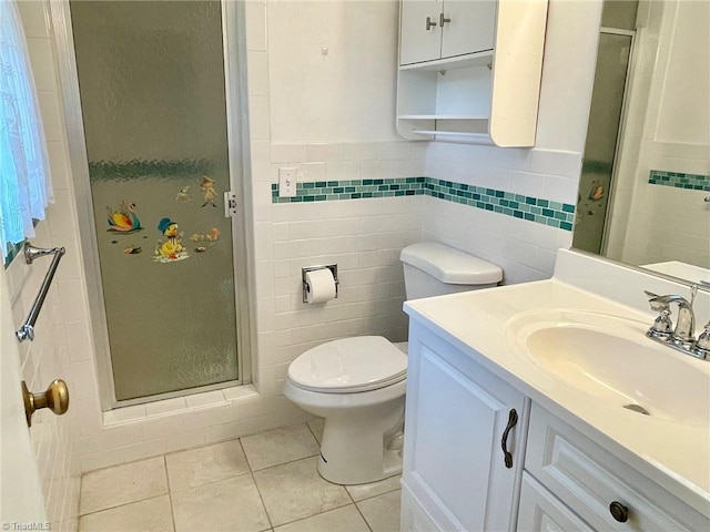 full bathroom featuring toilet, tile patterned flooring, vanity, a shower stall, and tile walls