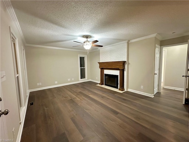 unfurnished living room featuring ceiling fan, dark wood-type flooring, crown molding, a textured ceiling, and a fireplace