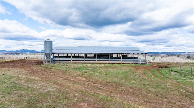 exterior space featuring an outdoor structure and a rural view