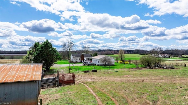 view of yard with a shed and a rural view