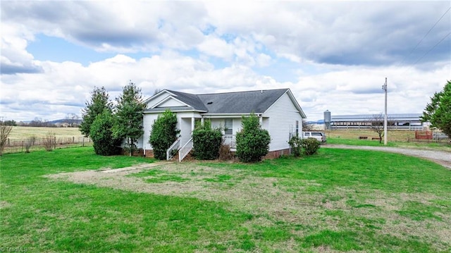 view of side of home with a lawn