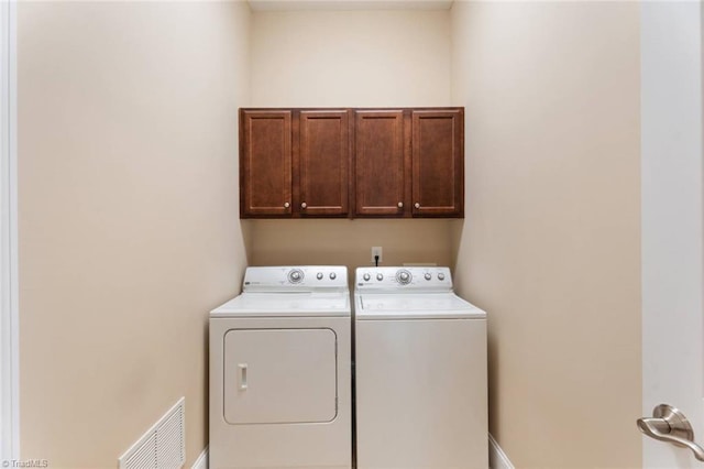 5584 Foxgate Cir, Winston-Salem, NC 27106 - laundry room with washer and dryer, cabinet space, and baseboards