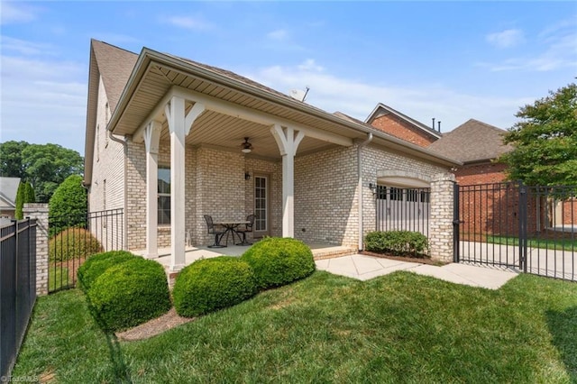 5584 Foxgate Cir, Winston-Salem, NC 27106 - view of front of house featuring brick siding, a ceiling fan, a shingled roof, and a gate