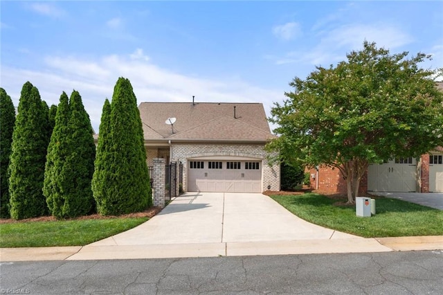 5584 Foxgate Cir, Winston-Salem, NC 27106 - view of front of property with brick siding, concrete driveway, an attached garage, a front lawn, and a shingled roof