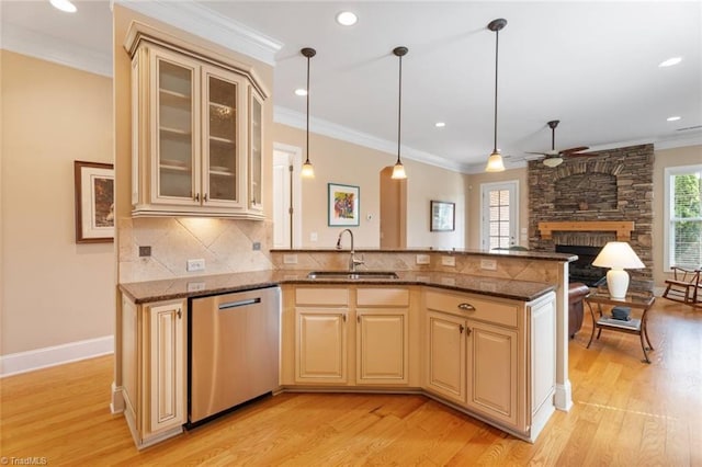 5584 Foxgate Cir, Winston-Salem, NC 27106 - kitchen with stainless steel dishwasher, a sink, light wood-type flooring, ceiling fan, and tasteful backsplash