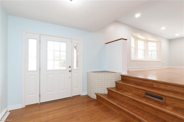 entrance foyer with visible vents, baseboards, a baseboard radiator, light wood-style floors, and recessed lighting