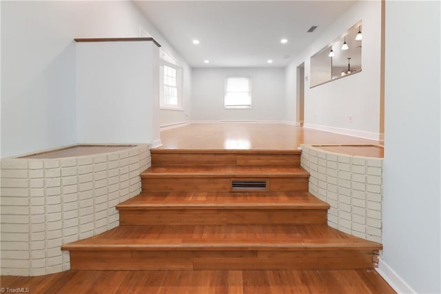 staircase featuring recessed lighting and wood finished floors