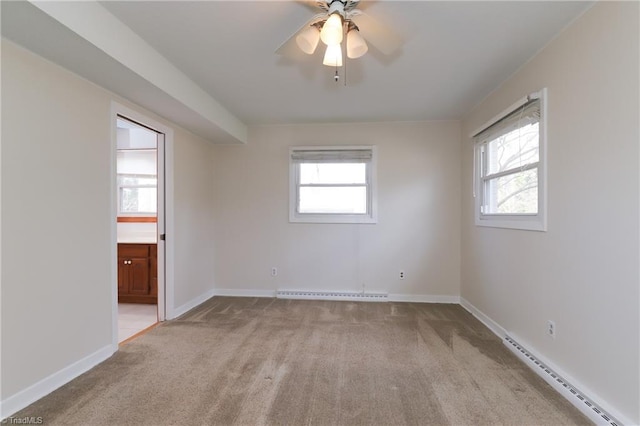 spare room featuring a ceiling fan, a baseboard radiator, light carpet, and baseboards