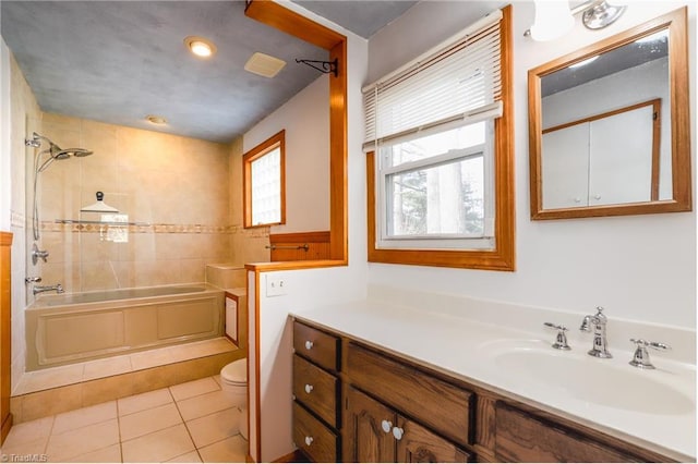 full bath with tub / shower combination, vanity, toilet, and tile patterned floors