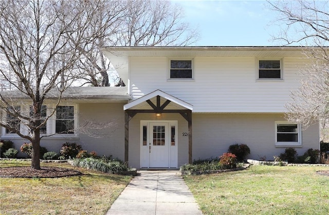 view of front of property with a front lawn and brick siding