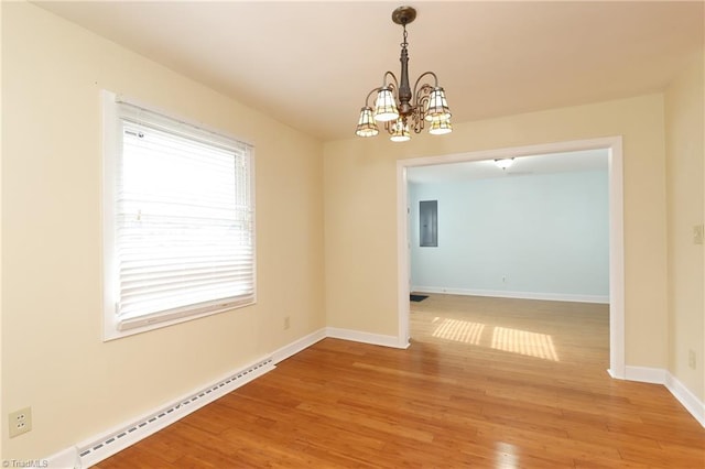 interior space with light wood finished floors, a baseboard radiator, an inviting chandelier, and baseboards