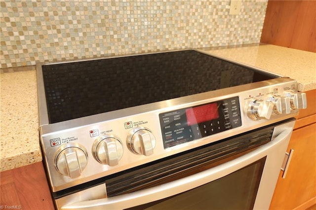 room details with electric range and decorative backsplash