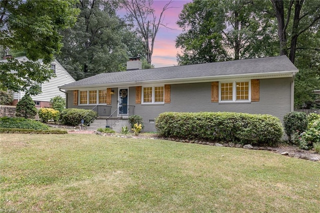 view of front of property with a lawn