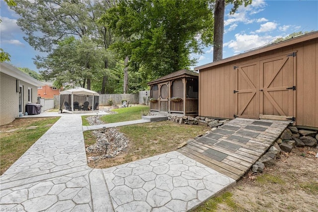 view of yard featuring a gazebo and a storage unit