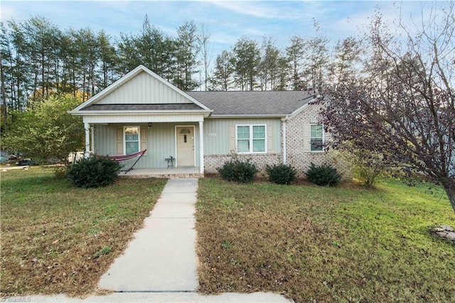 view of front of home with a porch and a front yard