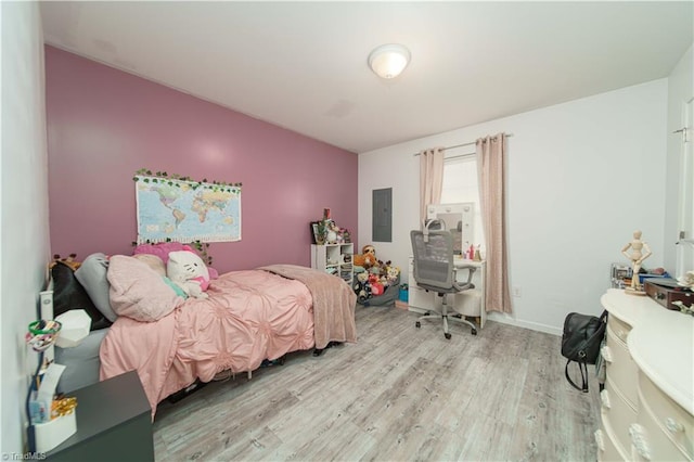 bedroom featuring electric panel and light hardwood / wood-style floors