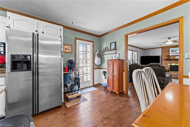 kitchen featuring a textured ceiling, white cabinets, dark hardwood / wood-style floors, and stainless steel refrigerator with ice dispenser