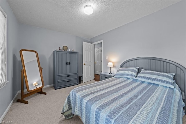 carpeted bedroom with a textured ceiling