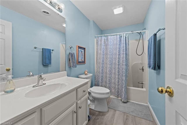 full bathroom with shower / tub combo, hardwood / wood-style flooring, toilet, and vanity