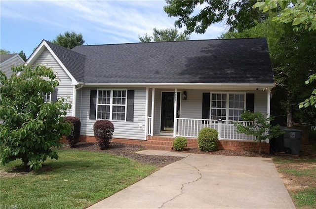 4711 Tuliptree Dr, Greensboro, NC 27455 - view of front of home featuring a porch, a front yard, and roof with shingles