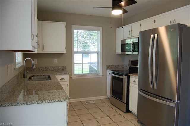 4711 Tuliptree Dr, Greensboro, NC 27455 - kitchen featuring appliances with stainless steel finishes, a sink, white cabinets, and a ceiling fan