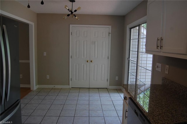 4711 Tuliptree Dr, Greensboro, NC 27455 - unfurnished dining area featuring light tile patterned floors and baseboards