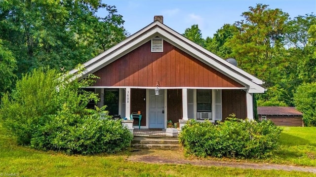 3608 Bernie Rd, Climax, NC 27233 - view of front of home featuring covered porch, a chimney, cooling unit, and a front lawn
