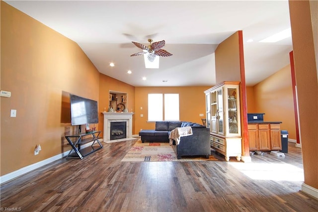 living room featuring ceiling fan, dark wood-type flooring, and lofted ceiling