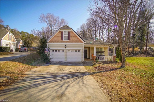 view of front of home featuring a porch, a garage, and a front yard