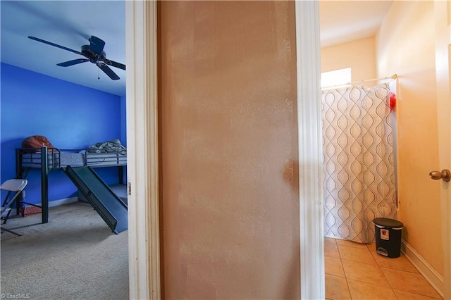 interior space with tile patterned flooring and ceiling fan