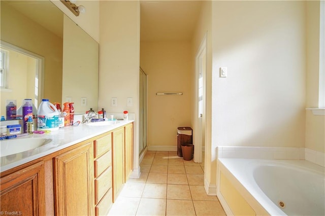 bathroom with a tub, tile patterned flooring, and vanity