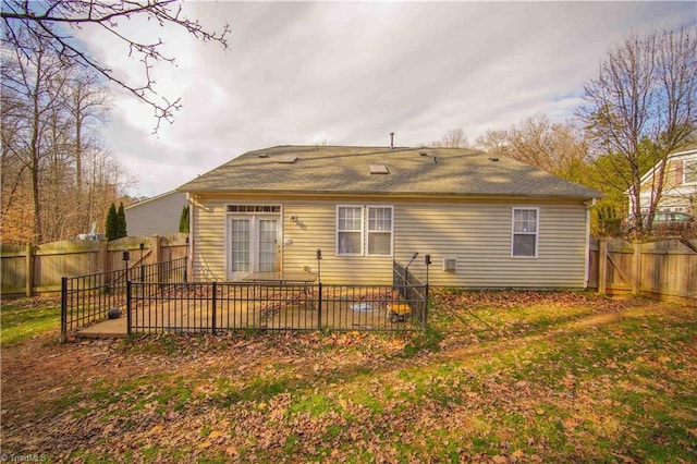 back of house with a lawn