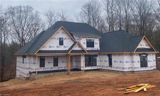 unfinished property featuring a shingled roof