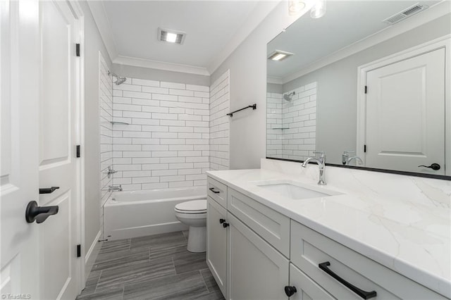 full bathroom with crown molding, vanity, toilet, and tiled shower / bath combo