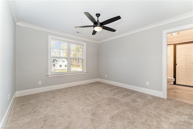 carpeted spare room with crown molding and ceiling fan