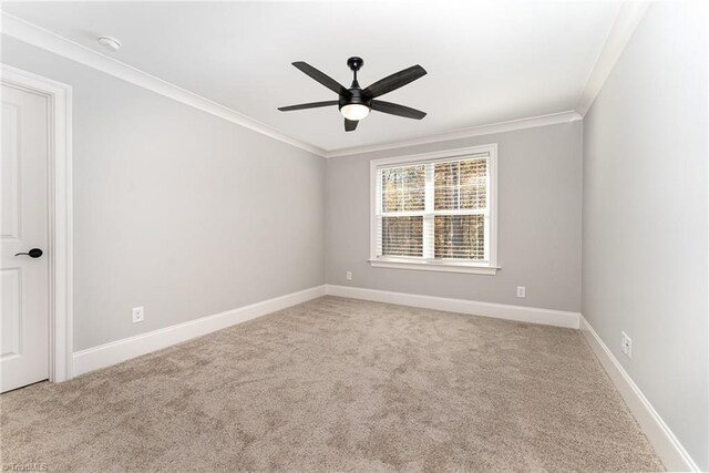 spare room with light carpet, crown molding, and ceiling fan