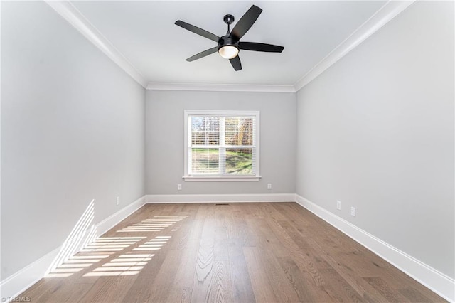 spare room with hardwood / wood-style flooring, ornamental molding, and ceiling fan