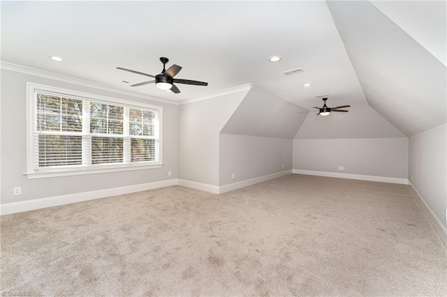 additional living space featuring vaulted ceiling, light colored carpet, and ceiling fan