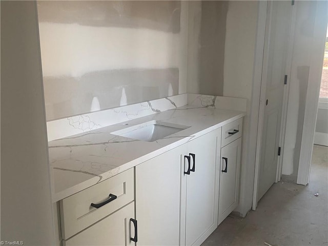 bathroom with vanity and concrete floors