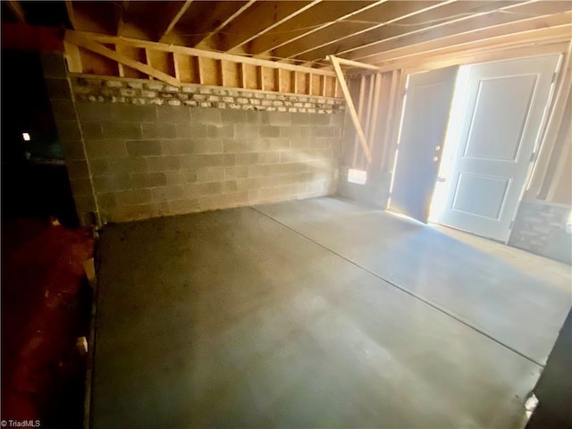 below grade area featuring concrete block wall