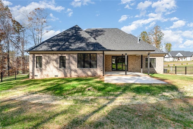 back of house with fence, brick siding, a patio, crawl space, and a yard