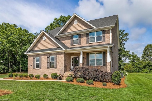 6605 Hedgerow Ct, Summerfield, NC 27358 - craftsman inspired home with brick siding, a front lawn, and a porch